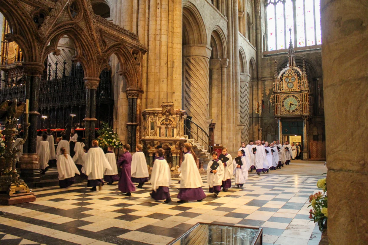 Childrens choir walking through cathedral